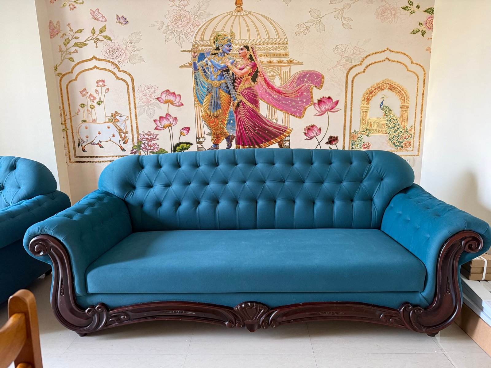 Blue upholstered carved-frame sofa
