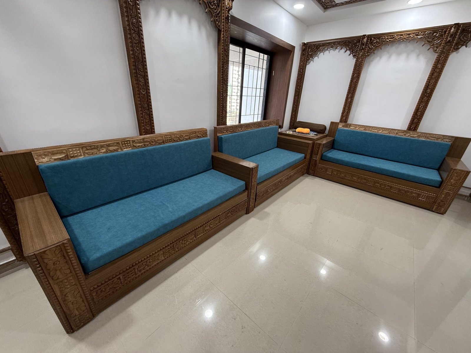Carved wooden sofa set with blue upholstery
