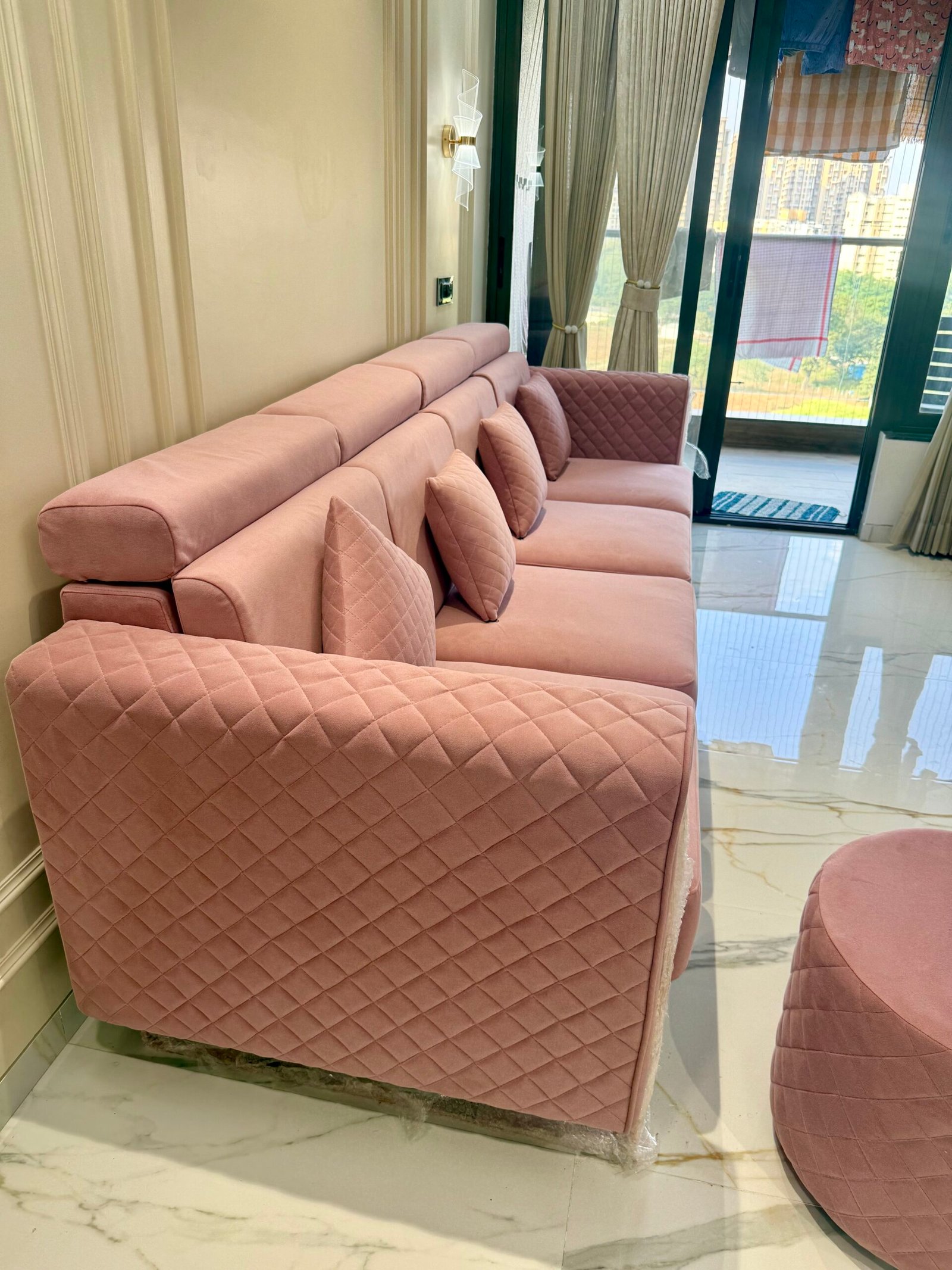 Pink quilted sofa in a modern living room