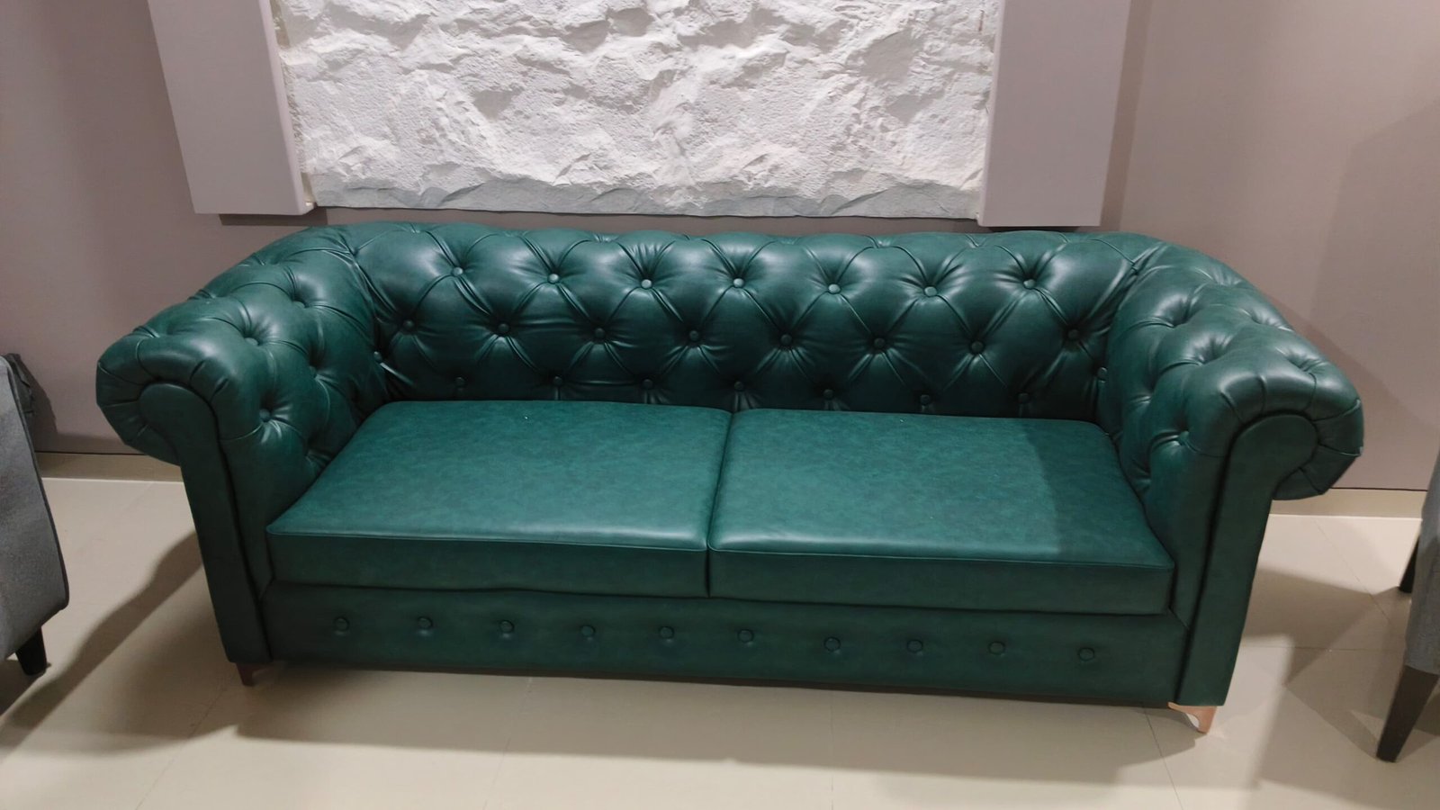 Green button tufted sofa